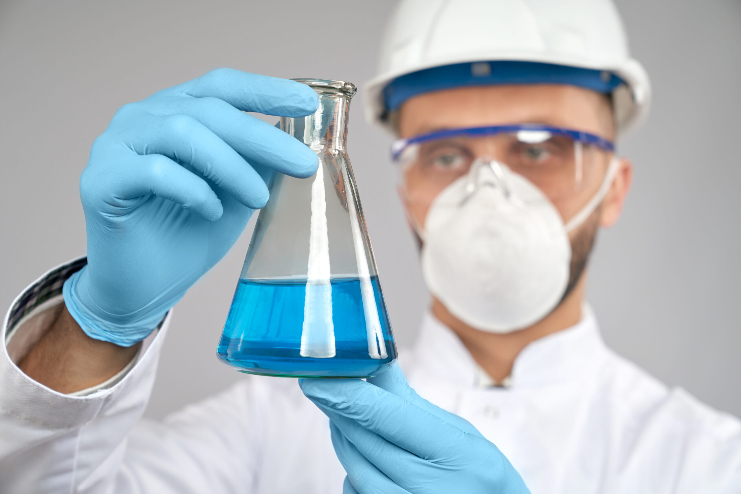 Close up of flask with blue liquid.